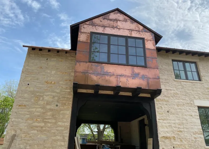 Copper metal panel facade on a stone building for Skylight Installation in Creedmoor